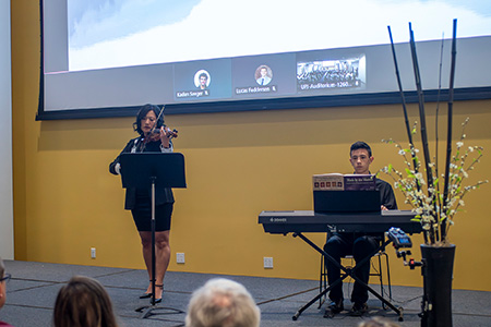 Julie VanGyseghem, PhD, and her son perform “Ave Maria” at the Annual Donor Remembrance Ceremony at WMed