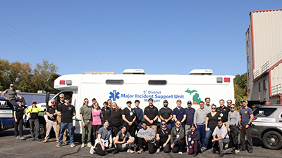 Residents and fellows pose for a group photo during EMS Day at the Kalamazoo Regional Fire Training Center