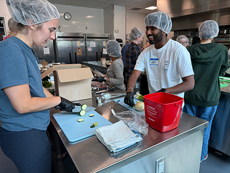 Two WMed students from the Class of 2030 prepare vegetable curry during a culinary medicine event at Kalamazoo Valley Community College on Wednesday, July 22, 2026