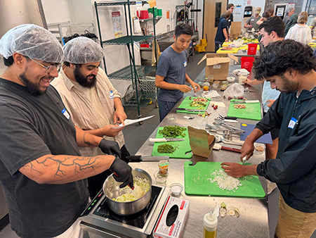A group of WMed students prepares vegetable curry during a culinary medicine event at Kalamazoo Valley Community College on Wednesday, July 22, 2026
