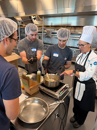 A group of WMed students prepares vegetable curry during a culinary medicine event at Kalamazoo Valley Community College on Wednesday, July 22, 2026